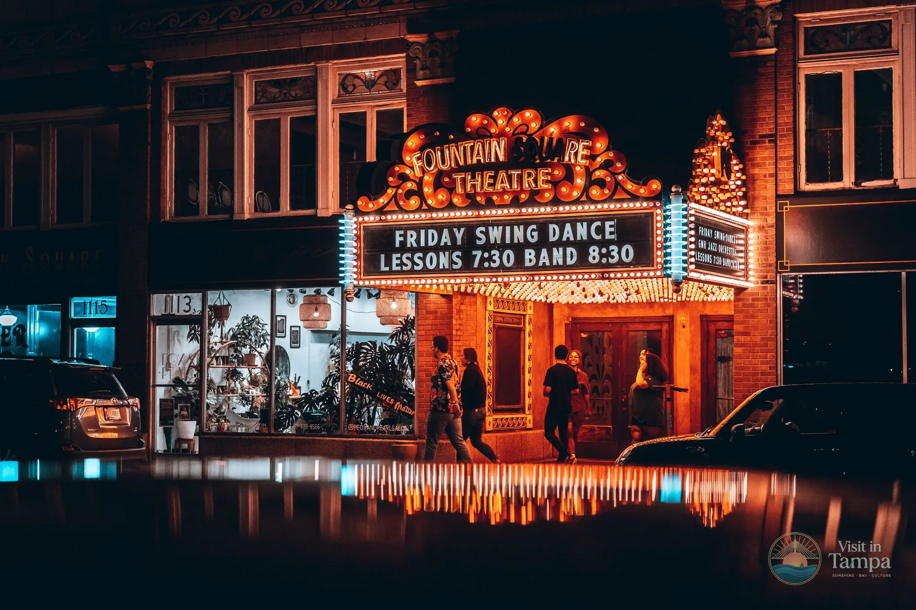 Tampa Theatre exterior on North Franklin Street in downtown Tampa, with the marquee lit at dusk
