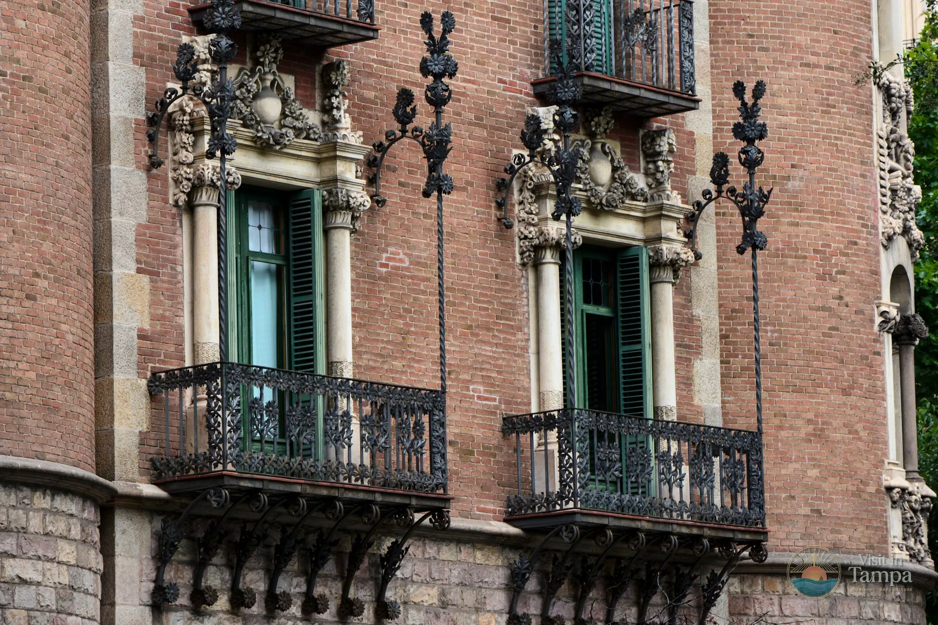 Brick storefronts and wrought-iron balconies along 7th Avenue in Ybor City, Tampa