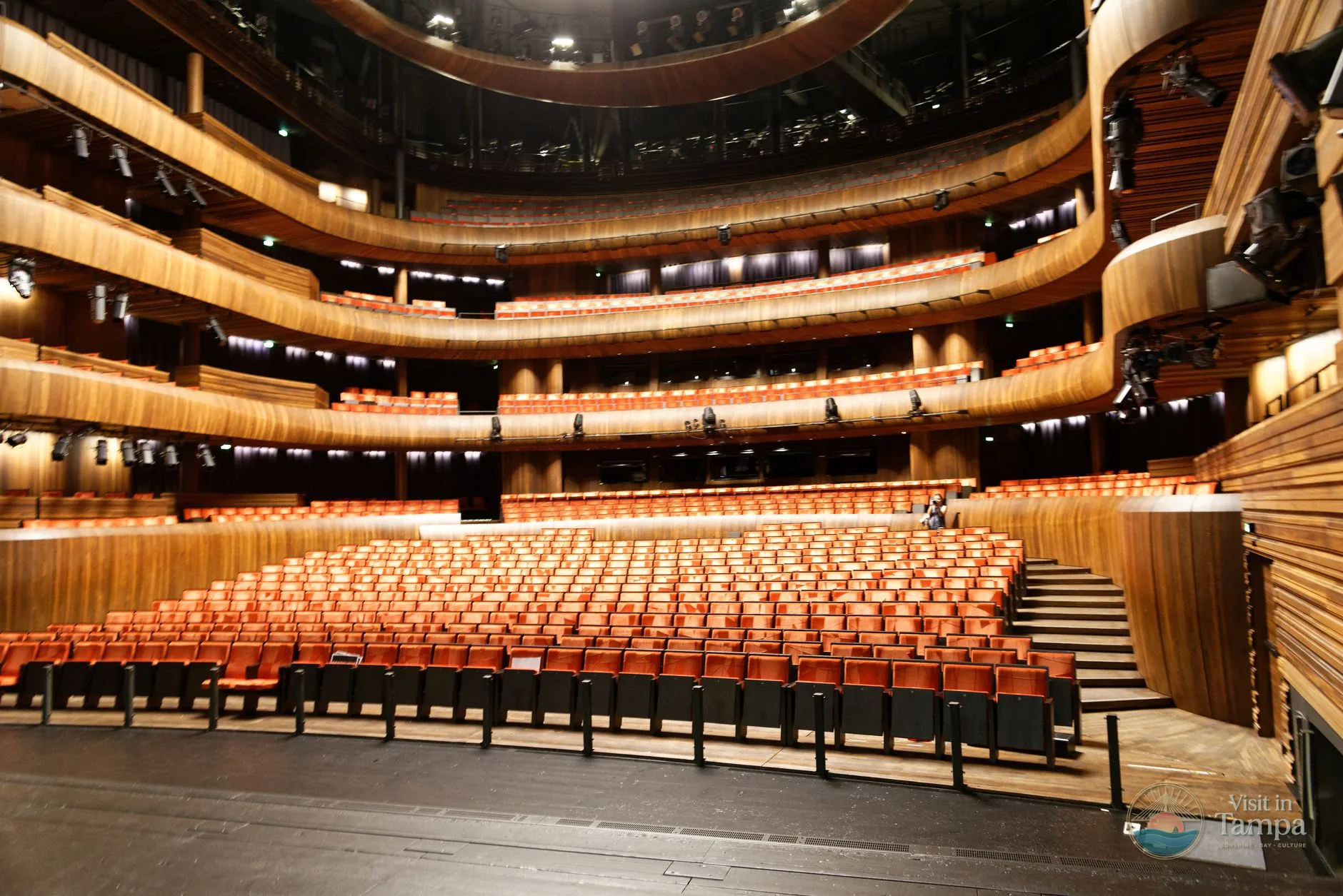 Orchestra seating with cupholders and the stage visible inside Tampa Theatre in downtown Tampa